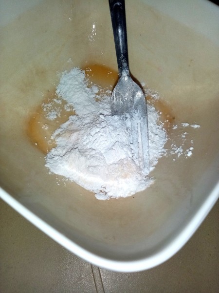 Mixing together the wet coating for the eggs.