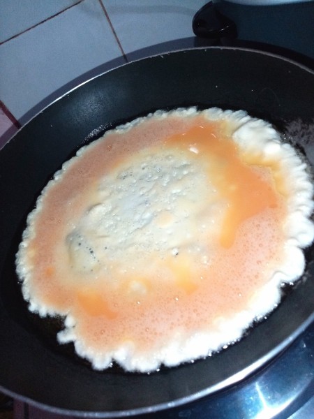 Cooking the scrambled eggs.