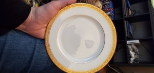 A china plate with a gold rim.