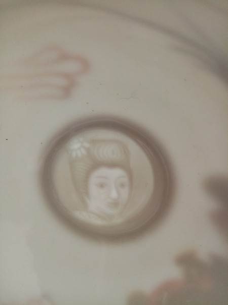 A Japanese woman on a set of china.