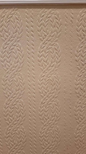 A textured wallpaper in an off white color.