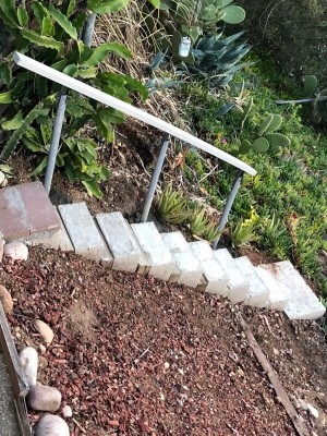 The completed railing next to stairs.