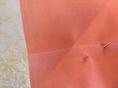 A corner pinned to a square.