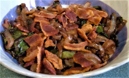 Adding bacon to the friend greens.