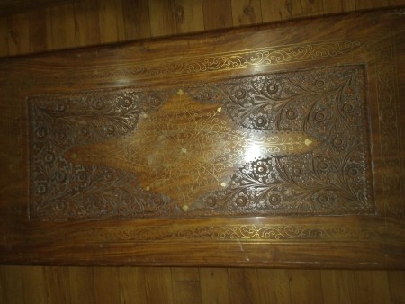 The top of a carved wooden trunk.