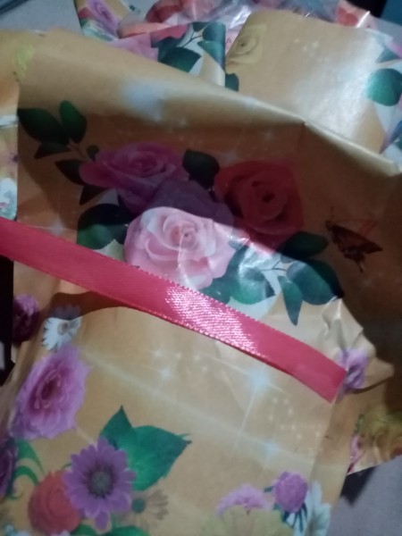 Wrapping the bouquet in paper with a ribbon.