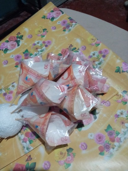 A collection of money flowers attached to styrofoam.