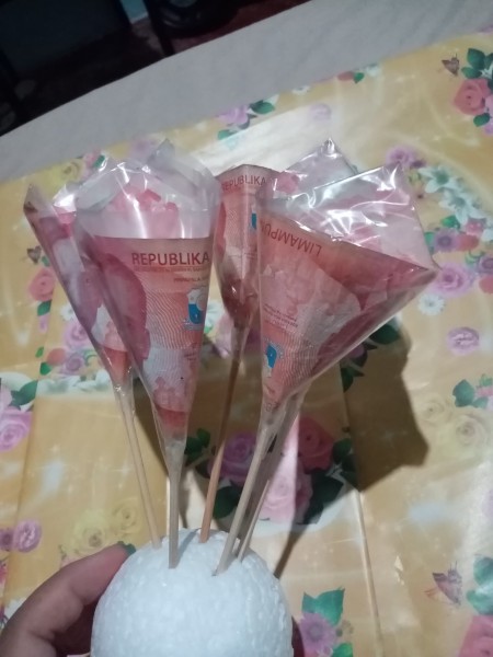 A collection of money flowers attached to styrofoam.