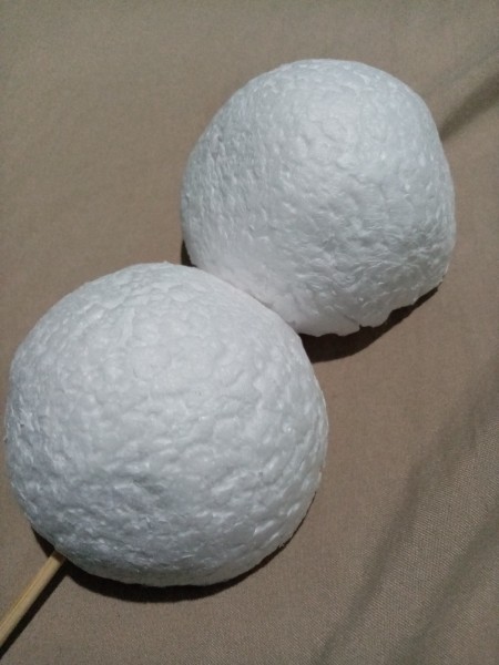 Attaching two styrofoam balls to the skewers.