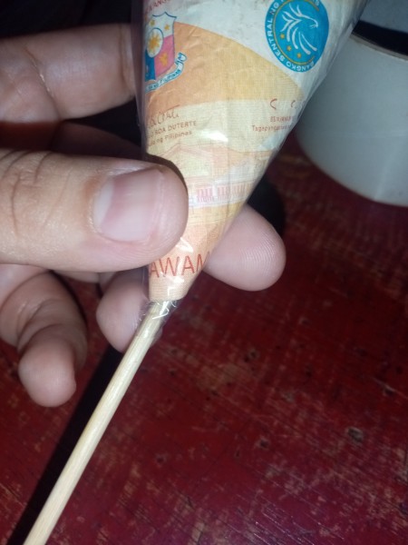 Attaching the money cone to a skewer.