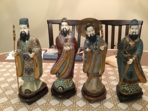 A set of four Asian figurines.