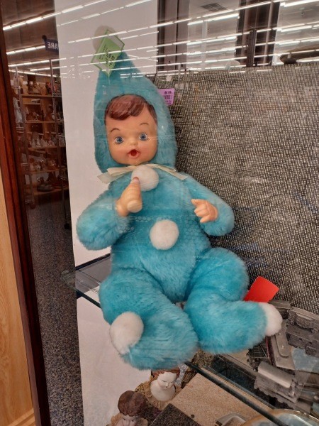 A small doll with a stuffed body.