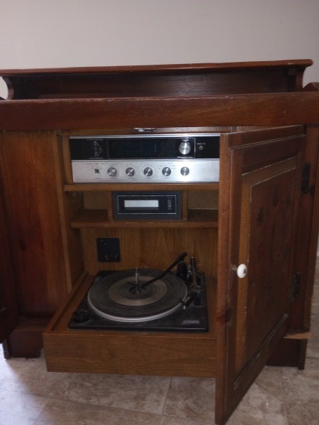 The open console showing controls and a record player.