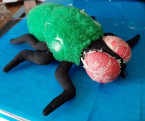 A stuffed toy resembling a fly.