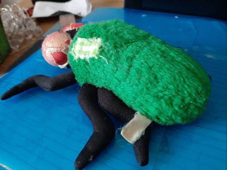 A stuffed toy resembling a fly.