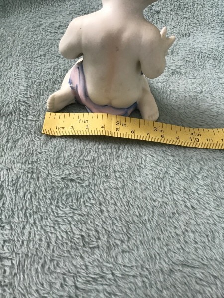 Measuring the figurine.