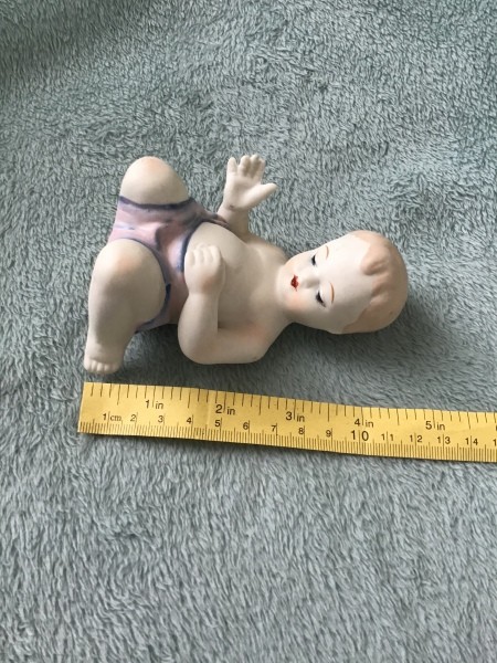 Measuring the figurine.