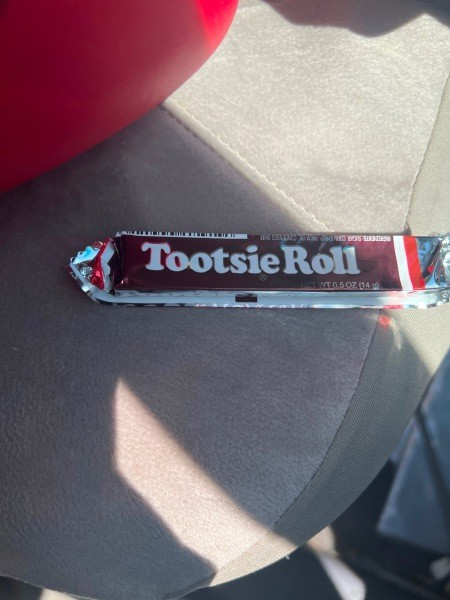 A Tootsie roll with a foil wrapper.
