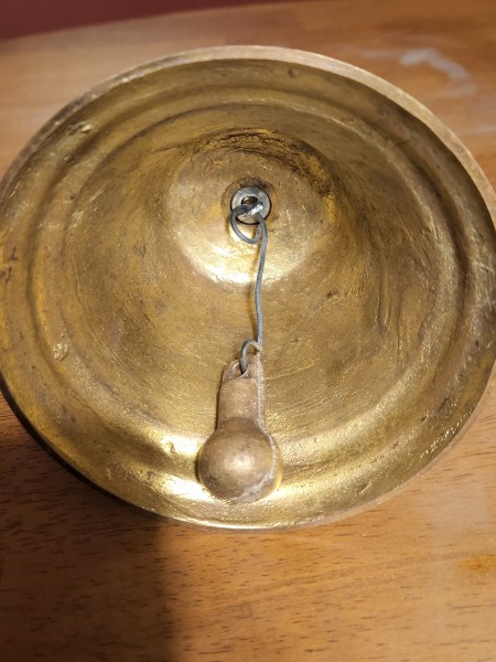 Inside the bell and the clapper.