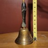 A brass hand bell used in school.