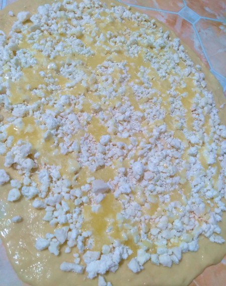 Adding cheese to the dough mixture.