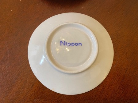 A china plate with the word "Nippon" on the back.