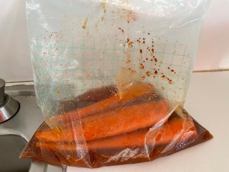Adding the carrots to the spice mixture.