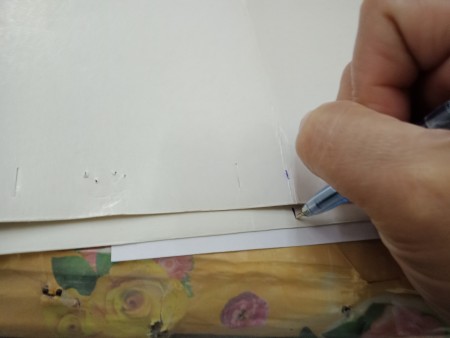 Marking the distance on the cardstock.