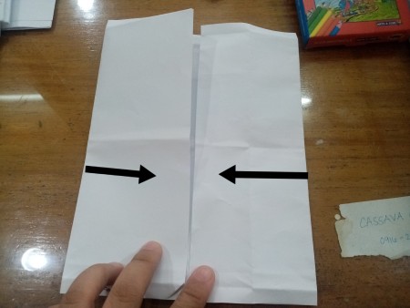 Folding the sides of the paper.
