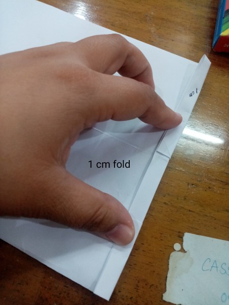 Making a small fold on the side of the paper.