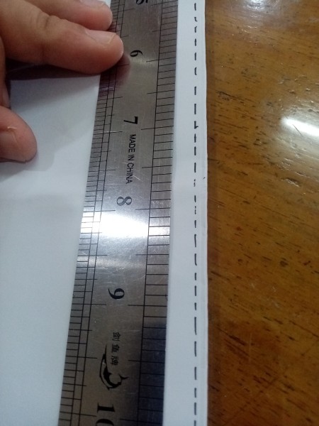 Marking a seam with a ruler.