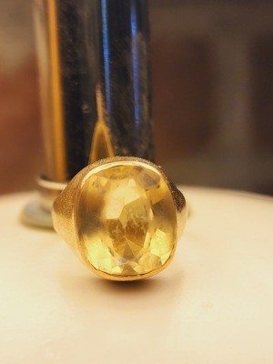 A ring with a yellow stone.