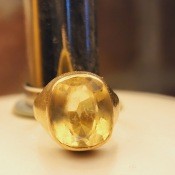 A ring with a yellow stone.
