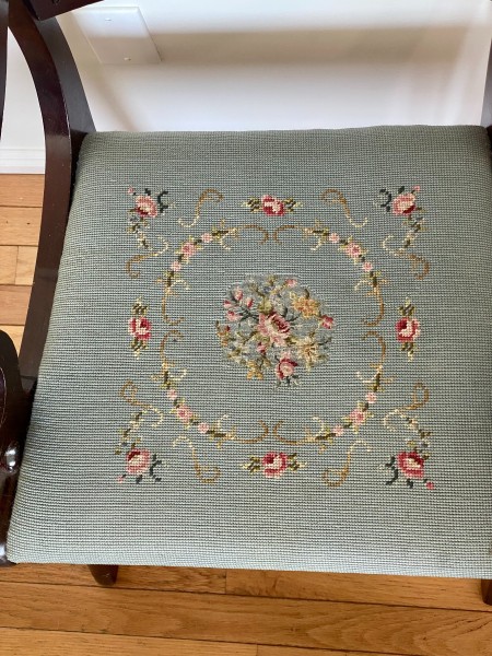 The embroidered seat of a dining chair.