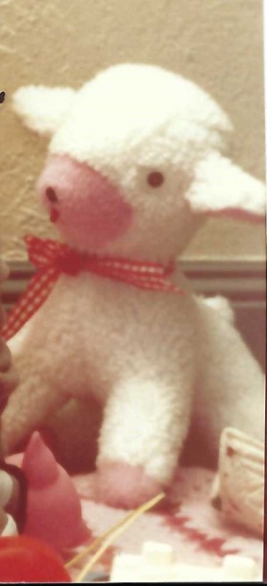 A stuffed lamb with a bow.