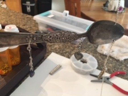 Attaching chains to the silverware.