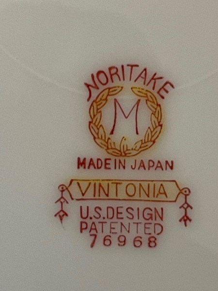 The markings on the back of a set of china.