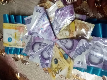 Wrapped and folded money to resemble a flower.