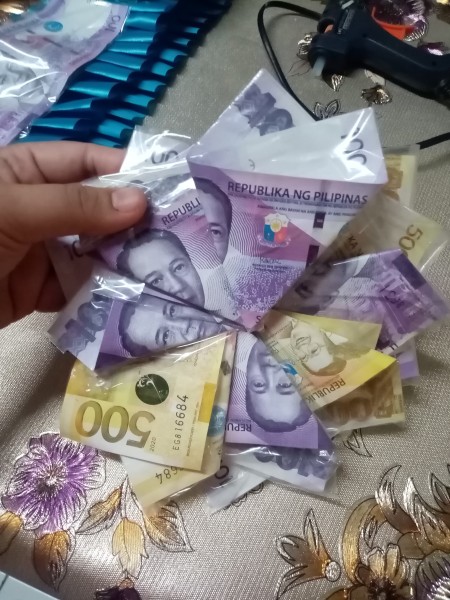 Wrapped and folded money to resemble a flower.