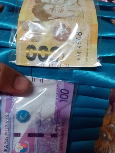 Adding money to the belt.