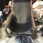 A leather chair with a wooden frame.