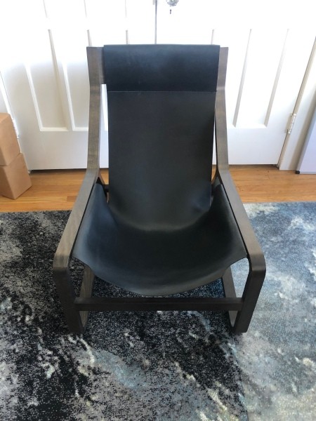 Front view of wooden chair frame with leather seat.