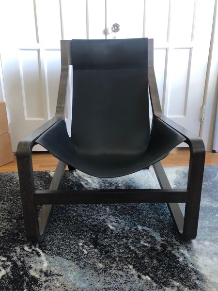Front view of wooden chair with leather seat.