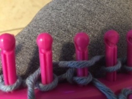 Using the loom to make the bag.