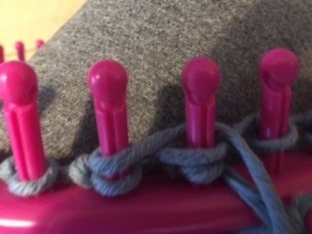 Using the loom to make the bag.