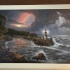 A print of the painting a lighthouse during a storm.