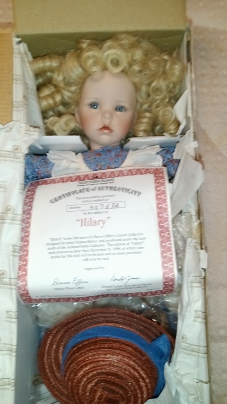 A porcelain doll in a box.