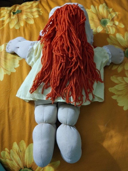 The back of a red-haired Cabbage Patch doll.