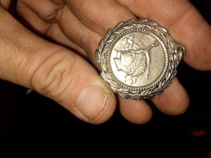 A round silver pendant.