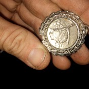 A round silver pendant.